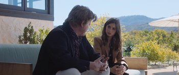 Movie still from “Windfall” (2022), directed by Charlie McDowell – A man and a woman sitting next to each other; Medium shot, Over the shoulder angle