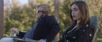 Movie still from “Windfall” (2022), directed by Charlie McDowell – Two people sitting on a bench in a park; Medium shot, Over the shoulder angle