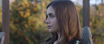 Movie still from “Windfall” (2022), directed by Charlie McDowell – A person with long brown hair; Close Up shot, Low angle