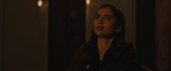 Movie still from “Windfall” (2022), directed by Charlie McDowell – A woman is looking up at the ceiling; Close Up shot, Over the shoulder angle