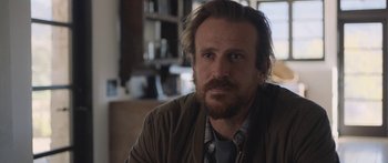 Movie still from “Windfall” (2022), directed by Charlie McDowell – A person with a beard; Close Up shot, Over the shoulder angle