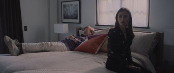 Movie still from “Windfall” (2022), directed by Charlie McDowell – A woman sitting on a bed next to a man in bed; Medium shot, Over the shoulder angle