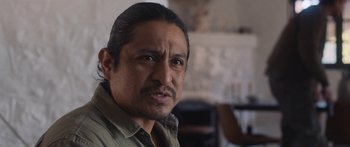 Movie still from “Windfall” (2022), directed by Charlie McDowell – A person wearing a shirt; Close Up shot, Over the shoulder angle