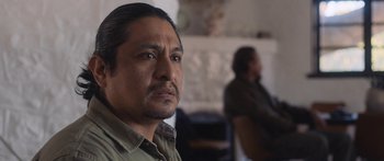 Movie still from “Windfall” (2022), directed by Charlie McDowell – A person sitting in a room; Close Up shot, Over the shoulder angle