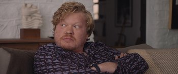 Movie still from “Windfall” (2022), directed by Charlie McDowell – A person sitting on a couch with his arms crossed; Close Up shot, Over the shoulder angle