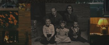 Movie still from “Wormwood” (2017), directed by Errol Morris – An old photo of a family sitting on the ground; Medium shot, High angle