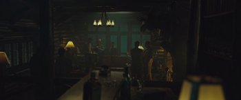 Movie still from “Wormwood” (2017), directed by Errol Morris – A group of people are gathered in a dark room; Wide shot, Low angle