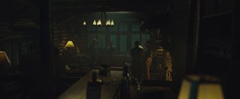 Movie still from “Wormwood” (2017), directed by Errol Morris – A group of people are gathered in a dark room; Wide shot, Low angle