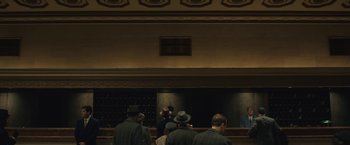 Movie still from “Wormwood” (2017), directed by Errol Morris – A group of men standing in front of a bar; Extreme Wide shot, Low angle