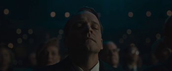Movie still from “Wormwood” (2017), directed by Errol Morris – A man with his eyes closed in a dark room; Close Up shot, Low angle