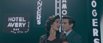 Movie still from “Wormwood” (2017), directed by Errol Morris – A man and a woman standing next to each other; Medium shot, Low angle