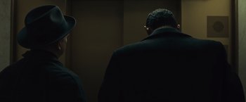 Movie still from “Wormwood” (2017), directed by Errol Morris – A man wearing a suit and a hat; Close Up shot, Low angle