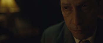 Movie still from “Wormwood” (2017), directed by Errol Morris – A man's face in the dark; Extreme Close Up shot, Over the shoulder angle
