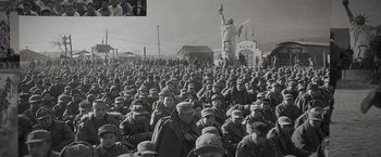 Movie still from “Wormwood” (2017), directed by Errol Morris – A large group of men in military uniforms; Wide shot, High angle
