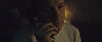 Movie still from “Wormwood” (2017), directed by Errol Morris – A person talking on a cell phone; Close Up shot, High angle