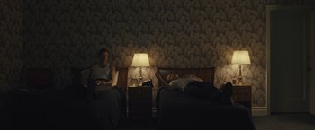 Movie still from “Wormwood” (2017), directed by Errol Morris – A couple of people that are laying in a bed; Wide shot, High angle