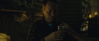 Movie still from “Wormwood” (2017), directed by Errol Morris – A man is looking at his cell phone in the dark; Close Up shot, Low angle