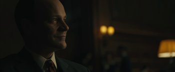 Movie still from “Wormwood” (2017), directed by Errol Morris – A person wearing a suit and tie; Close Up shot, Low angle