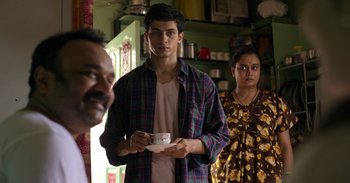 Movie still from “Yeh Ballet” (2020), directed by Sooni Taraporevala – A man and a woman standing next to each other holding a bowl; Medium shot, Over the shoulder angle