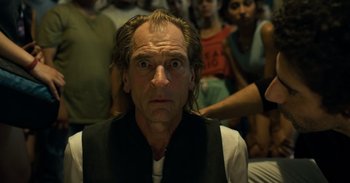 Movie still from “Yeh Ballet” (2020), directed by Sooni Taraporevala – A man with long blonde hair and a black vest; Close Up shot, Low angle