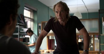 Movie still from “Yeh Ballet” (2020), directed by Sooni Taraporevala – A man standing in a room with a computer; Medium shot, Low angle