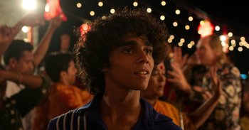 Movie still from “Yeh Ballet” (2020), directed by Sooni Taraporevala – A young man with curly brown hair is looking up; Close Up shot, Over the shoulder angle