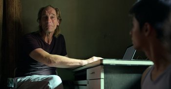 Movie still from “Yeh Ballet” (2020), directed by Sooni Taraporevala – An older man sitting at a desk with a laptop computer in front of him; Close Up shot, Over the shoulder angle