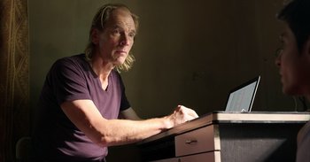 Movie still from “Yeh Ballet” (2020), directed by Sooni Taraporevala – A man sitting at a desk looking at a laptop computer; Close Up shot, Low angle