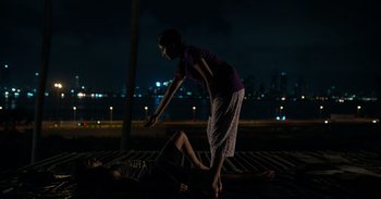 Movie still from “Yeh Ballet” (2020), directed by Sooni Taraporevala – A woman standing over a man laying on the ground; Wide shot, High angle