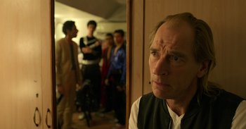 Movie still from “Yeh Ballet” (2020), directed by Sooni Taraporevala – An older man is standing in front of a group of people; Close Up shot, Over the shoulder angle