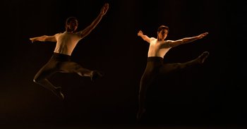 Movie still from “Yeh Ballet” (2020), directed by Sooni Taraporevala – Two male ballet dancers performing in the dark; Wide shot, Low angle