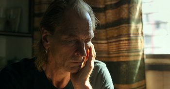 Movie still from “Yeh Ballet” (2020), directed by Sooni Taraporevala – An older man is sitting in a room with his head resting on his hand; Close Up shot, Low angle