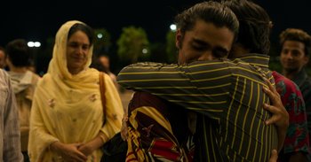 Movie still from “Yeh Ballet” (2020), directed by Sooni Taraporevala – A man hugging a woman in front of a crowd; Medium shot, Over the shoulder angle