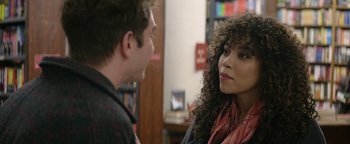 Movie still from “tick, tick... BOOM!” (2021), directed by Lin-Manuel Miranda – A man and a woman talking in a library; Close Up shot, Over the shoulder angle