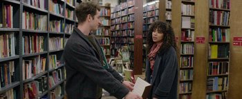 Movie still from “tick, tick... BOOM!” (2021), directed by Lin-Manuel Miranda – A man and a woman in a bookstore; Medium shot, Over the shoulder angle