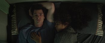 Movie still from “tick, tick... BOOM!” (2021), directed by Lin-Manuel Miranda – A man and a woman laying in a bed together; Medium shot, Overhead angle