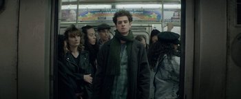 Movie still from “tick, tick... BOOM!” (2021), directed by Lin-Manuel Miranda – A group of people standing on a subway platform; Medium shot, Over the shoulder angle