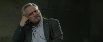 Movie still from “tick, tick... BOOM!” (2021), directed by Lin-Manuel Miranda – An older man in a jacket and shirt is looking up; Close Up shot, Over the shoulder angle