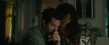 Movie still from “tick, tick... BOOM!” (2021), directed by Lin-Manuel Miranda – A man and a woman sitting next to each other; Medium shot, High angle