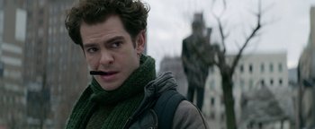 Movie still from “tick, tick... BOOM!” (2021), directed by Lin-Manuel Miranda – A man with a green scarf and a cigarette in his mouth; Close Up shot, Over the shoulder angle