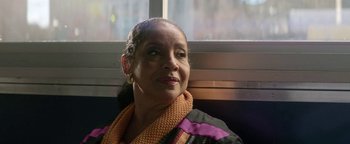 Movie still from “tick, tick... BOOM!” (2021), directed by Lin-Manuel Miranda – An older woman wearing a purple and black jacket; Close Up shot, Low angle