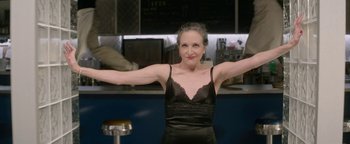 Movie still from “tick, tick... BOOM!” (2021), directed by Lin-Manuel Miranda – An older woman in a black dress with her arms outstreched; Medium shot, Low angle