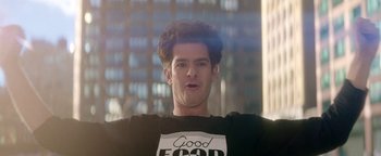 Movie still from “tick, tick... BOOM!” (2021), directed by Lin-Manuel Miranda – A man with curly hair wearing a good food t - shirt; Close Up shot, Low angle