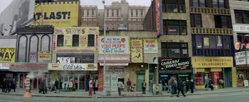 Movie still from “tick, tick... BOOM!” (2021), directed by Lin-Manuel Miranda – A group of people standing on a street corner; Extreme Wide shot, High angle