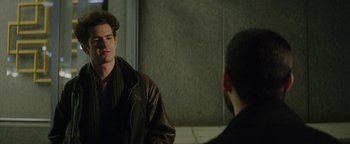 Movie still from “tick, tick... BOOM!” (2021), directed by Lin-Manuel Miranda – A man in a brown jacket is talking to another man in a brown jacket; Close Up shot, Over the shoulder angle