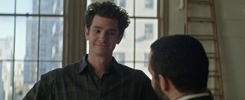 Movie still from “tick, tick... BOOM!” (2021), directed by Lin-Manuel Miranda – A man in a checkered shirt is looking at himself in the mirror; Close Up shot, Over the shoulder angle