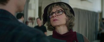 Movie still from “tick, tick... BOOM!” (2021), directed by Lin-Manuel Miranda – A person wearing glasses and a hat; Close Up shot, Over the shoulder angle