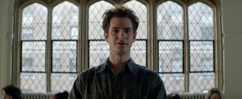 Movie still from “tick, tick... BOOM!” (2021), directed by Lin-Manuel Miranda – A man standing in front of a stained glass window; Close Up shot, Low angle