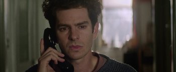 Movie still from “tick, tick... BOOM!” (2021), directed by Lin-Manuel Miranda – A person talking on a cell phone; Close Up shot, Over the shoulder angle