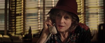 Movie still from “tick, tick... BOOM!” (2021), directed by Lin-Manuel Miranda – An older woman talking on a phone wearing a hat; Close Up shot, Over the shoulder angle
